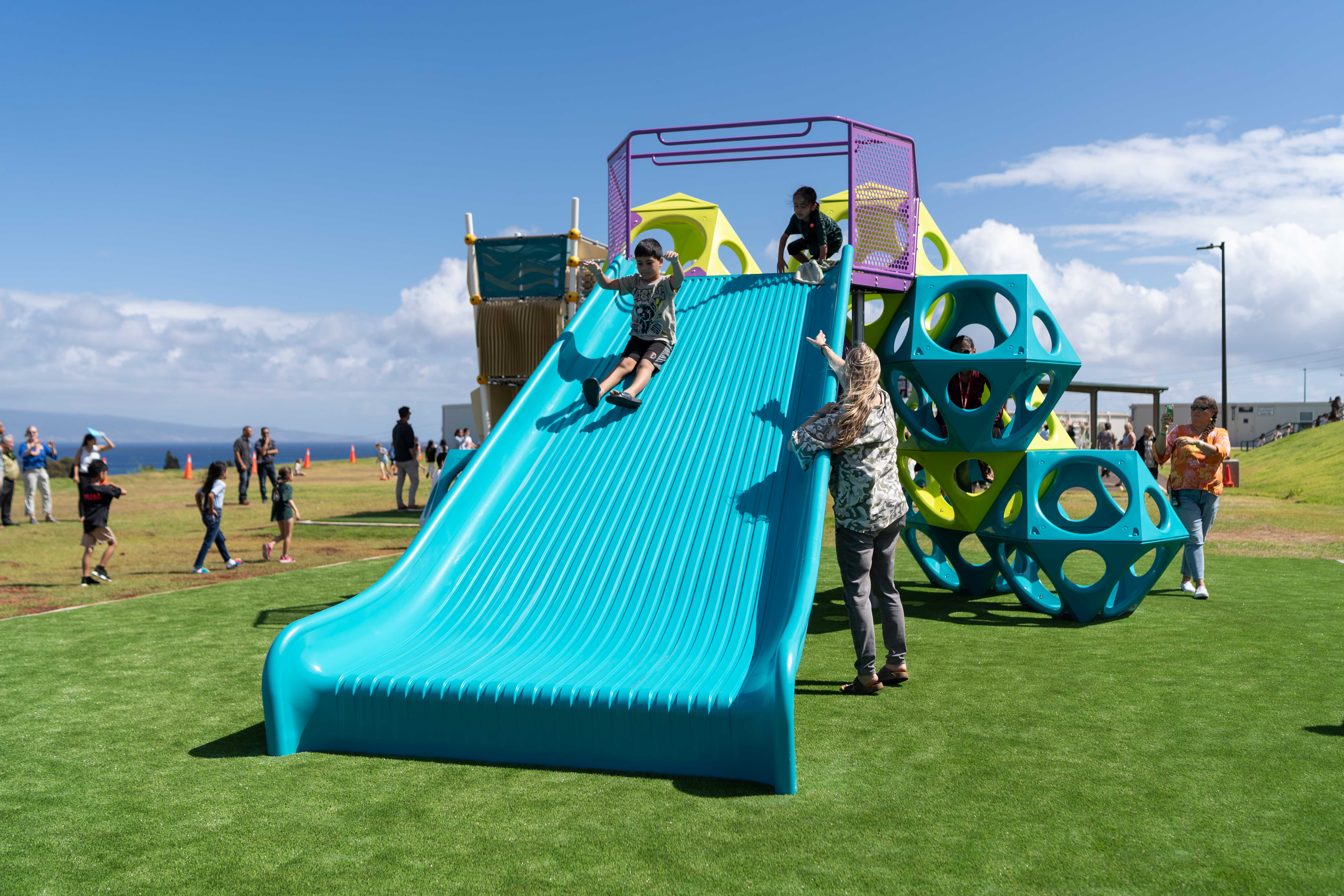 Children enjoying new playground equipment at a Hawaii public school